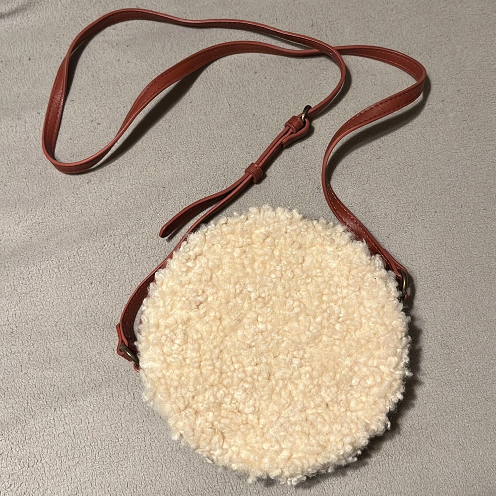 Brown leather crossbody with cream Sherpa detailing. Copper hardware.